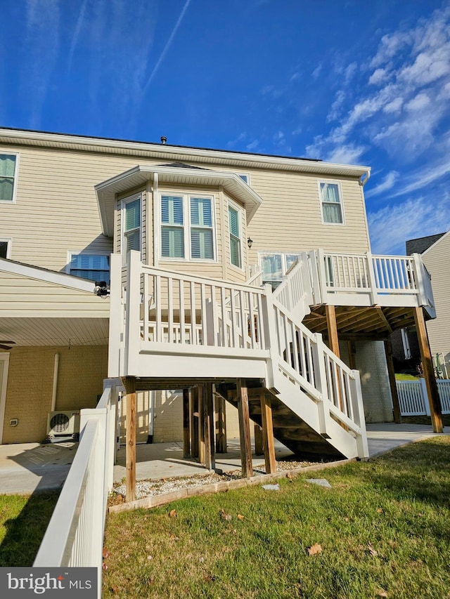 back of house featuring a lawn and a patio area