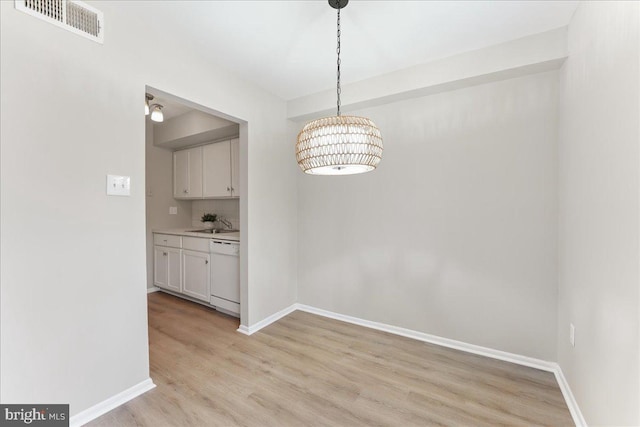 unfurnished dining area with light hardwood / wood-style floors and sink