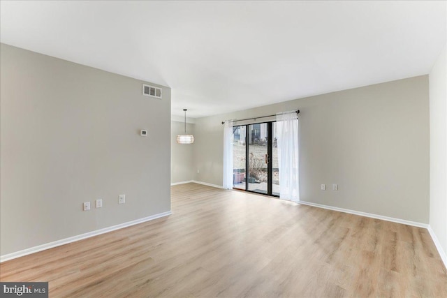 empty room with light hardwood / wood-style floors