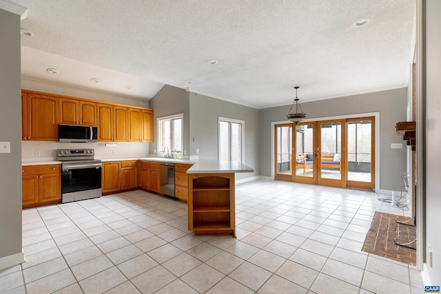 kitchen with kitchen peninsula, appliances with stainless steel finishes, french doors, light tile patterned floors, and decorative light fixtures