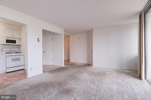 unfurnished living room featuring light carpet