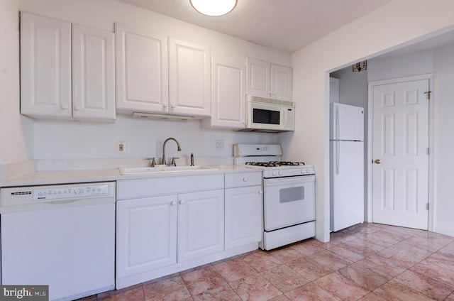 kitchen with white cabinets, white appliances, and sink