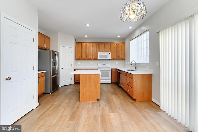 kitchen with light wood-type flooring, stainless steel appliances, sink, pendant lighting, and a kitchen island