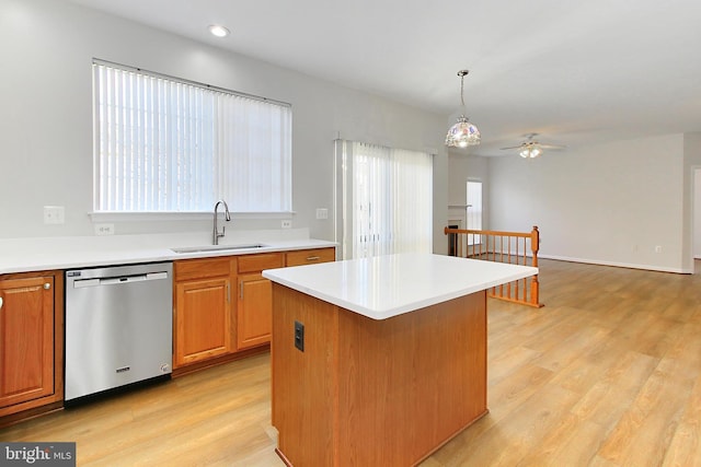 kitchen featuring ceiling fan, sink, decorative light fixtures, dishwasher, and a center island