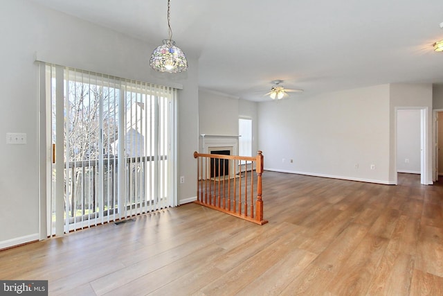 living room with ceiling fan and wood-type flooring