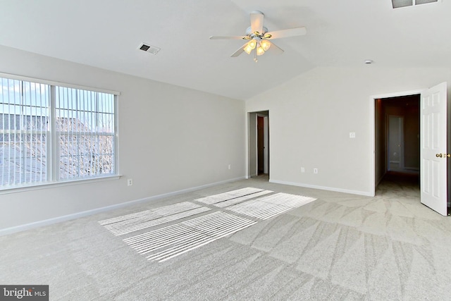 empty room featuring light carpet, ceiling fan, and lofted ceiling