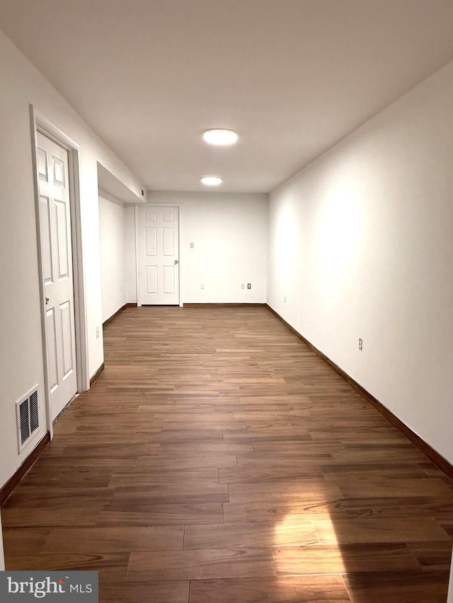 basement with dark hardwood / wood-style flooring