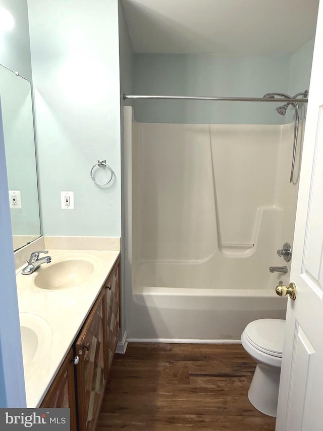 full bathroom with vanity, hardwood / wood-style flooring, toilet, and shower / bathtub combination