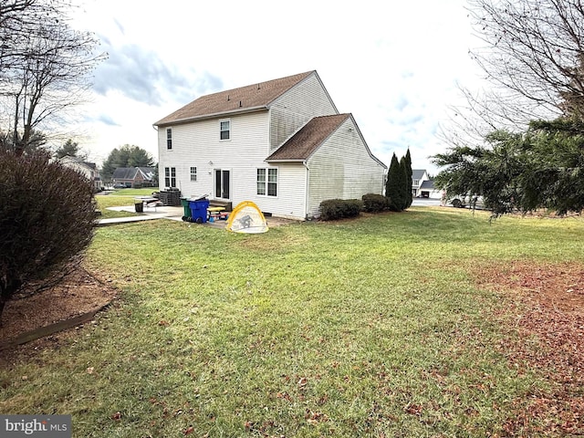 rear view of property with a yard