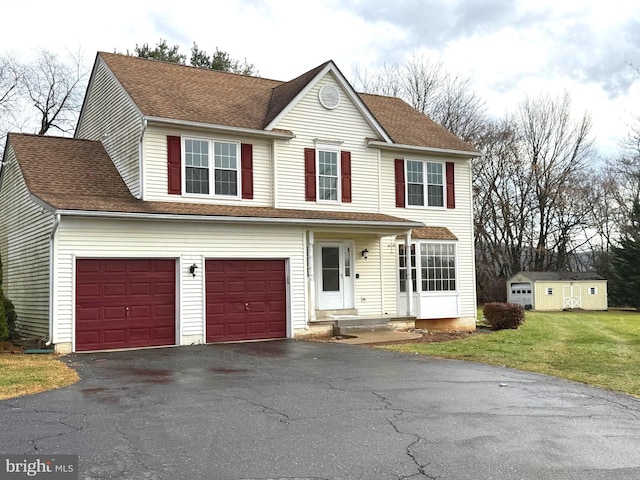 view of front of property featuring a garage and a front lawn