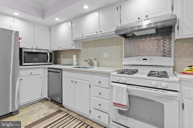 kitchen with sink, stainless steel appliances, backsplash, crown molding, and white cabinets