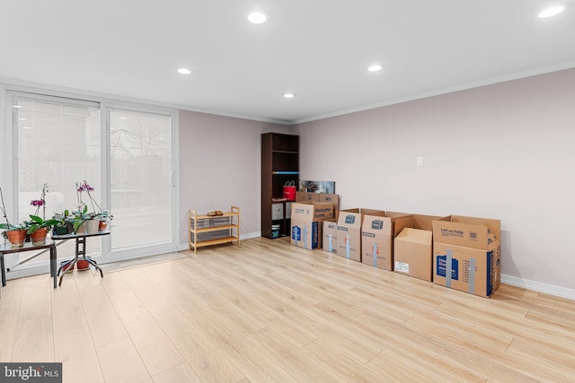 rec room with light hardwood / wood-style flooring and crown molding