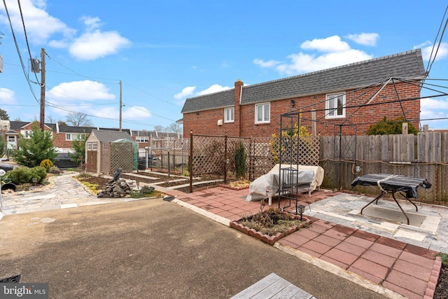 view of patio / terrace featuring a storage unit