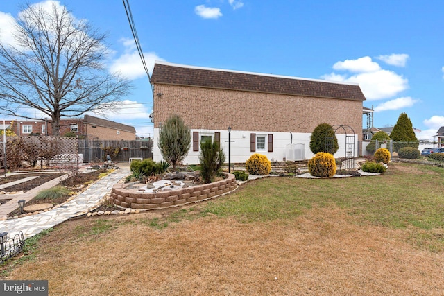 rear view of property featuring a yard