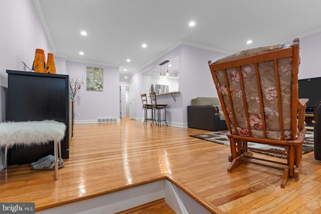 interior space featuring light hardwood / wood-style flooring and ornamental molding