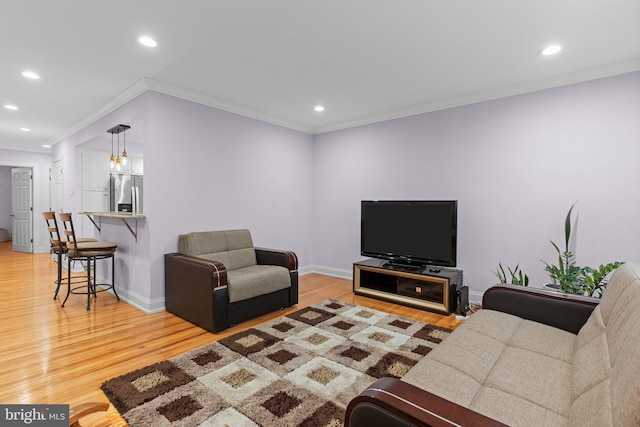 living room featuring crown molding and hardwood / wood-style flooring