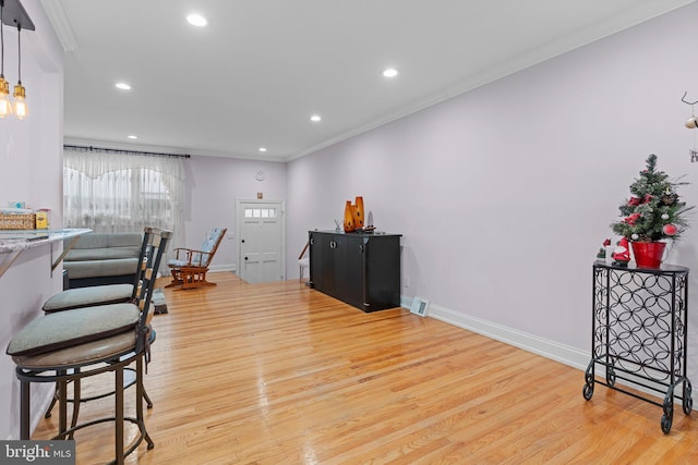 interior space with ornamental molding and light hardwood / wood-style flooring