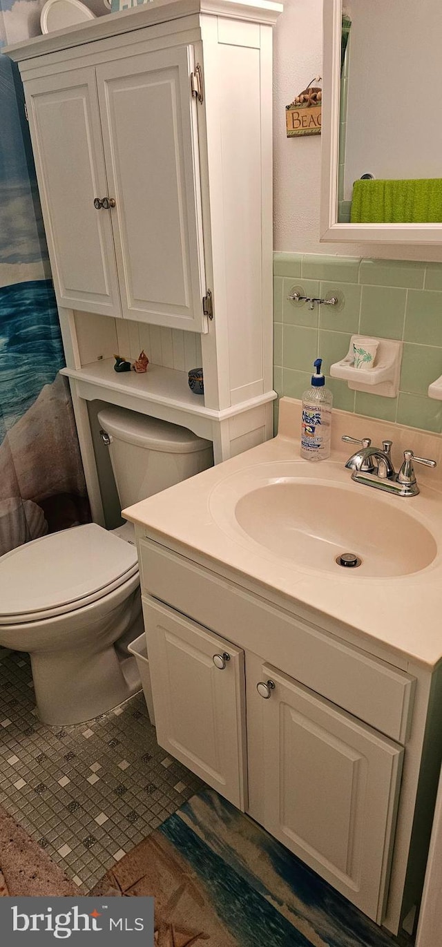 bathroom featuring toilet and vanity