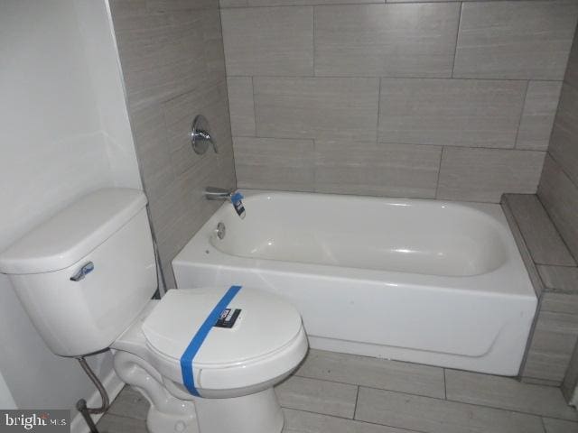 bathroom featuring tile patterned flooring and toilet