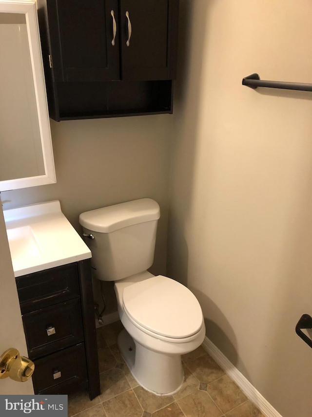 bathroom featuring tile patterned floors, vanity, and toilet