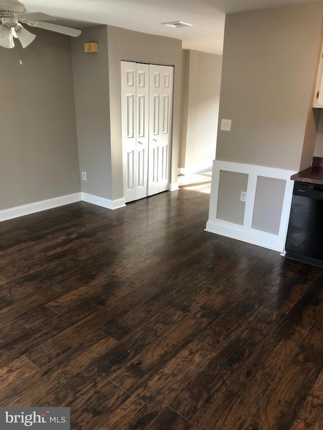 unfurnished room with ceiling fan and dark hardwood / wood-style flooring