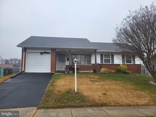 single story home with a garage and a front lawn