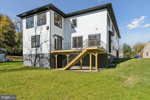 rear view of property featuring a yard and a deck