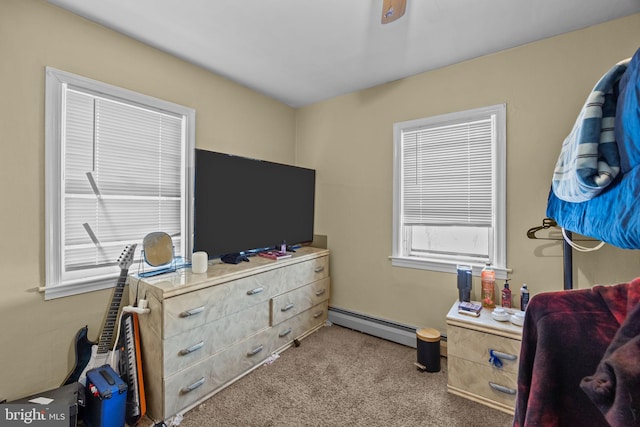 carpeted bedroom featuring a baseboard heating unit