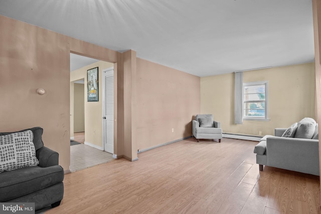 living room featuring baseboard heating and light hardwood / wood-style floors