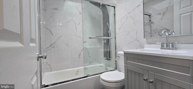 full bathroom with vanity, enclosed tub / shower combo, tile walls, and toilet