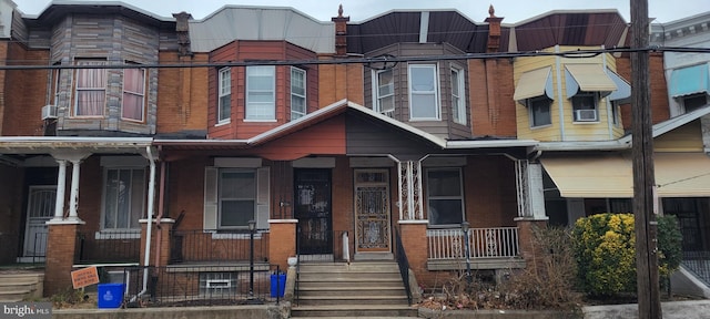 townhome / multi-family property featuring brick siding