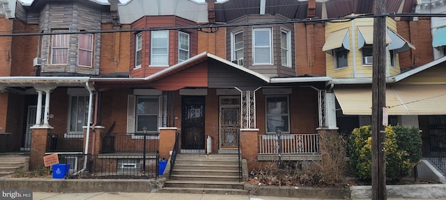 multi unit property with covered porch and brick siding