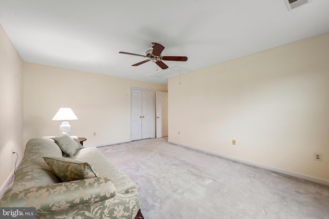 living area with ceiling fan and carpet