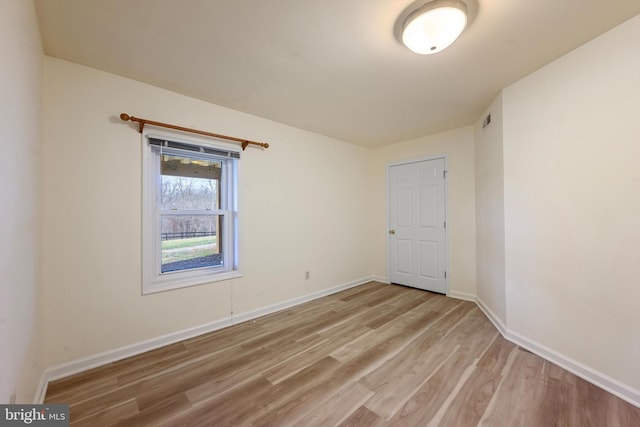 unfurnished room with light hardwood / wood-style floors