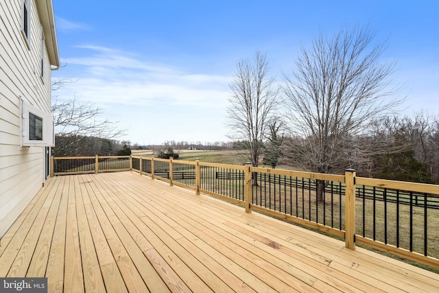 wooden deck with a rural view