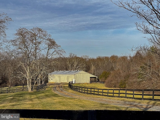 view of yard with an outbuilding and a rural view