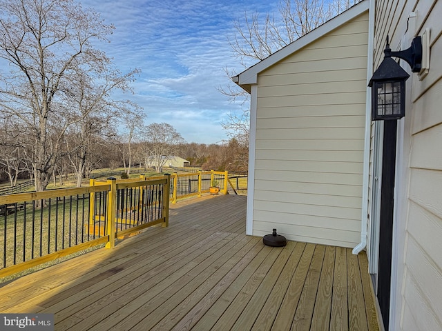 wooden deck featuring a lawn