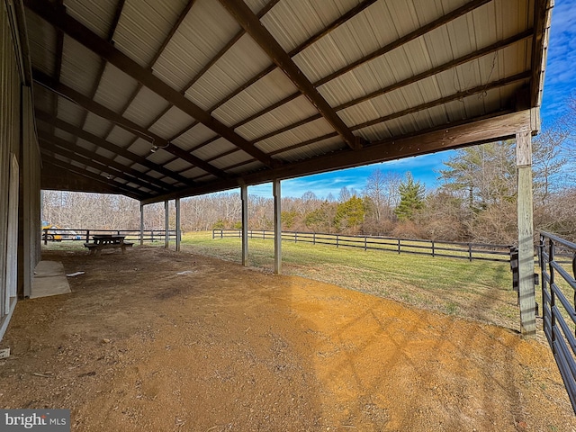 view of horse barn with a rural view