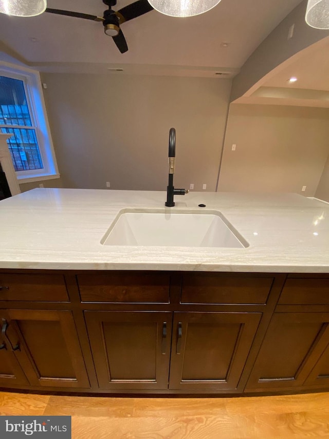 1750 S St NW Unit 1, Washington, DC 20009 - kitchen featuring a ceiling fan, light stone countertops, and dark brown cabinetry