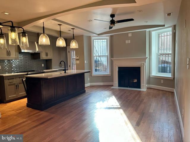1750 S St NW Unit 1, Washington, DC 20009 - kitchen featuring light countertops, ceiling fan, tasteful backsplash, wood finished floors, and beam ceiling