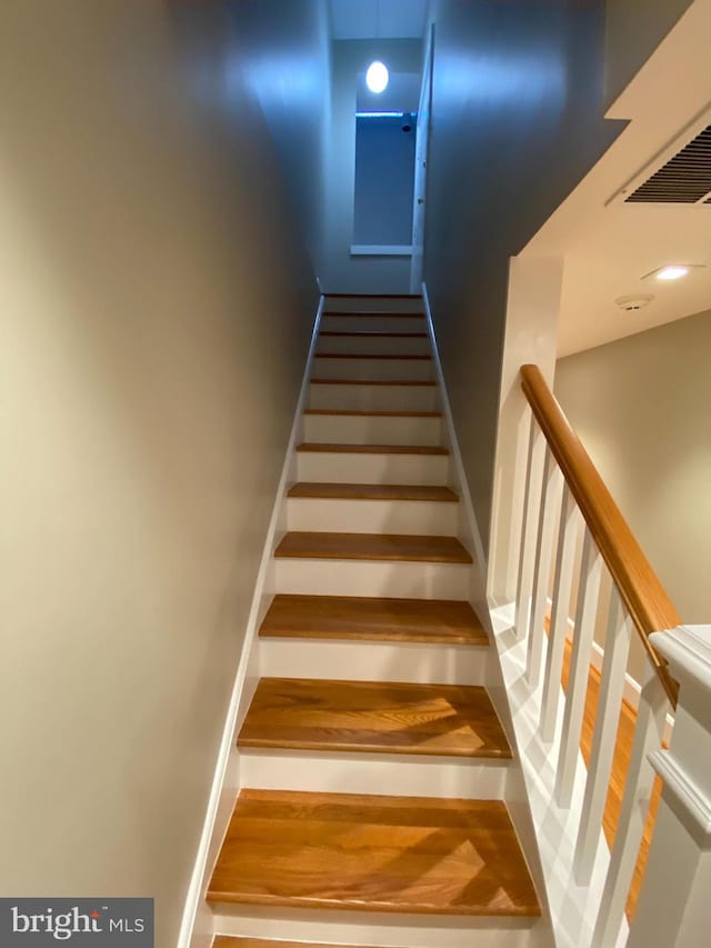 stairs with hardwood / wood-style flooring