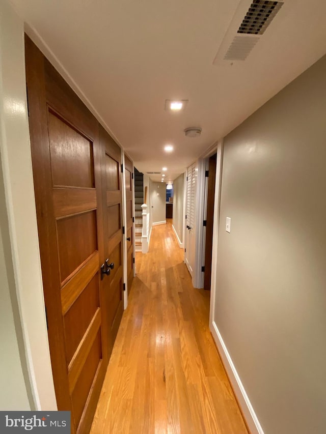 hallway with light hardwood / wood-style flooring