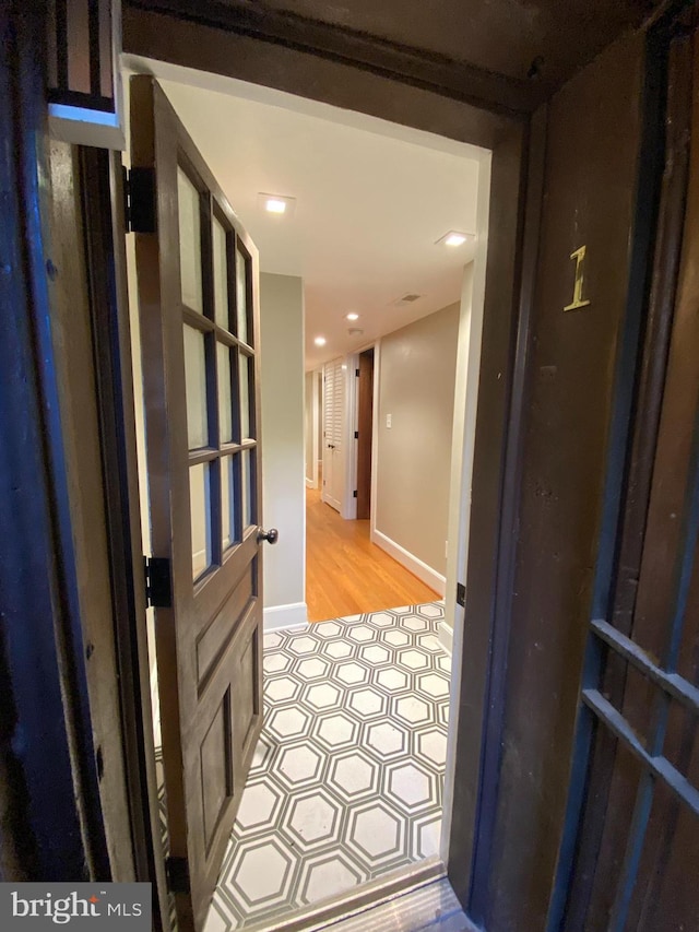 corridor with light wood-type flooring