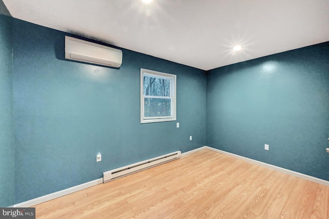 empty room with a wall mounted air conditioner, hardwood / wood-style floors, and a baseboard heating unit