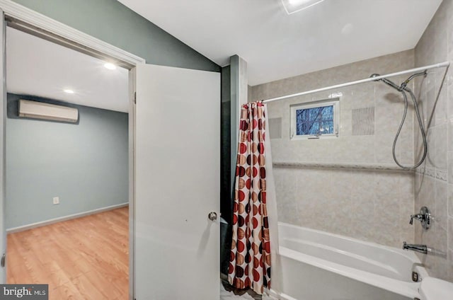 bathroom with a wall mounted air conditioner, wood-type flooring, and shower / bathtub combination with curtain