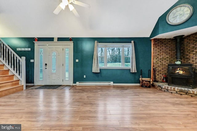 foyer entrance featuring ceiling fan, wood-type flooring, and a baseboard radiator