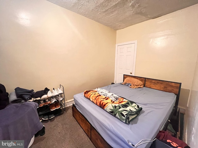 bedroom with a textured ceiling and carpet