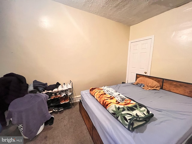 carpeted bedroom featuring a textured ceiling