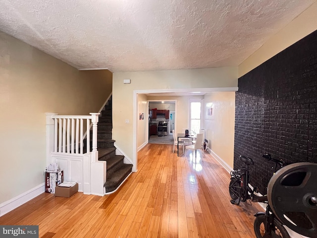 entrance foyer featuring light hardwood / wood-style flooring and a textured ceiling