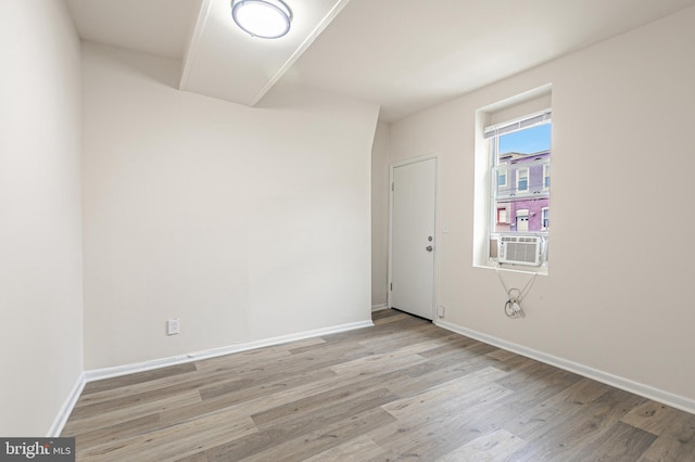 spare room with light hardwood / wood-style floors and cooling unit